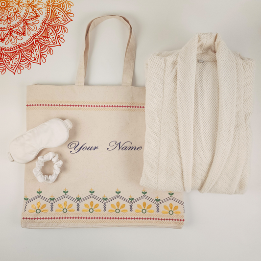 Gift set featuring a luxurious white bathrobe, soft eye mask, stylish scrunchie, and a complimentary personalized embroidered tote bag, perfect for the festive season.